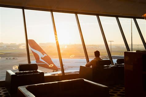 solo business traveler entering airline lounge before upgraded flight