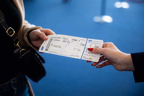 solo flyer at departure gate looking at electronic flight board