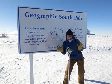 South Pole marker with visitors arriving via Beechcraft King Air flight
