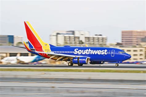 southwest 737 taking off from pittsburgh runway with city skyline in background