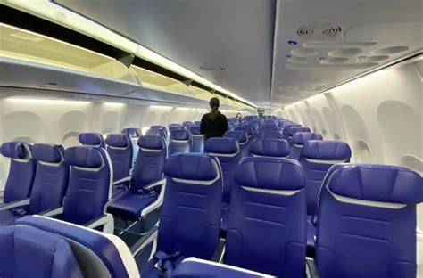 southwest airlines cabin economy section with open seating and happy passengers