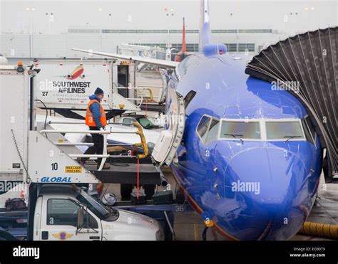 Southwest Airlines ground crew using heat gun on beverage crate under intense heatwave