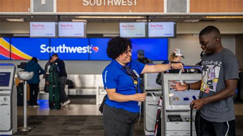 Southwest Airlines staff assisting passengers during rebooking at PVD terminal gate
