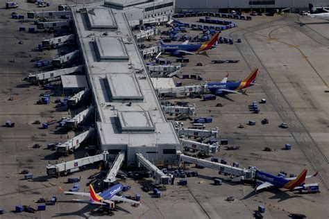 Southwest concourse at Midway with passengers crowded and minimal seating