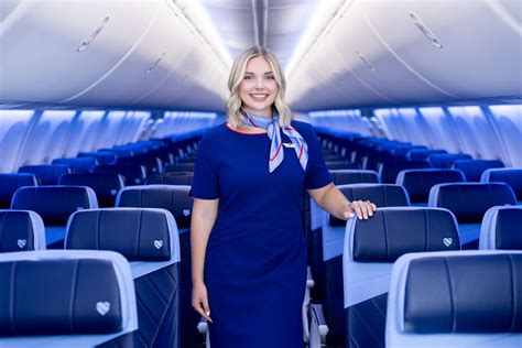 southwest flight attendant walking down aisle during beverage service