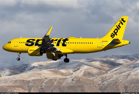 Spirit Airlines Airbus A320 climbing after takeoff against sunset sky