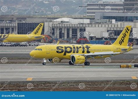Spirit Airlines Airbus A320 taxiing on runway during sunset at major US airport