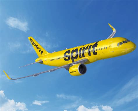 Spirit Airlines aircraft flying at sunset, symbolic of uncertain future trajectory