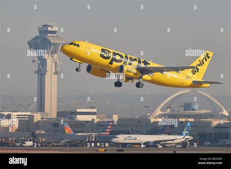 Spirit Airlines bright yellow Airbus A320 taking off