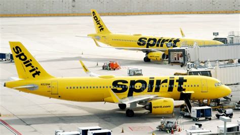 spirit airlines debt pressure cost cutting summer flight reductions