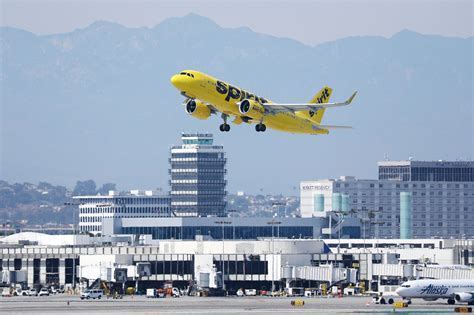 Spirit Airlines plane taxiing at LAS airport with Las Vegas skyline in background