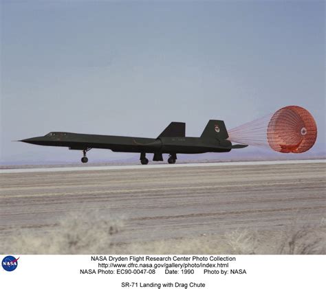 sr-71 blackbird landing with drag chute deployed on hot tarmac