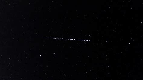 Starlink satellite constellation visible as streaks across night sky