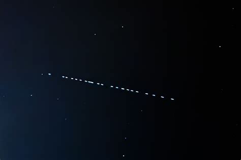 Starlink satellites crossing a dark astronomical observatory sky during telescope observations