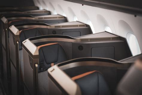 STARLUX long haul flight passenger enjoying business class suite window view sunrise