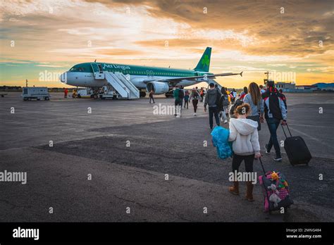 stranded Aer Lingus passengers at Dublin Airport checking rebooking options due to strike