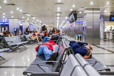 stranded airline passengers sleeping in airport terminal during Middle East flight cancellations