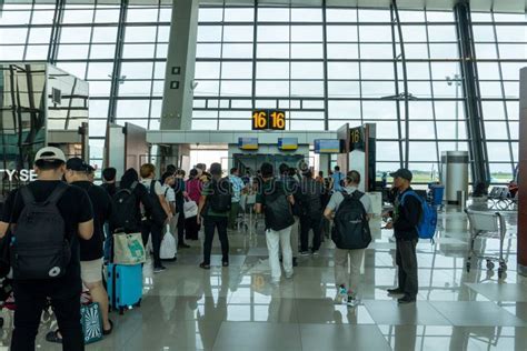 stranded passengers queue at Jakarta Soekarno-Hatta International Airport during flight crisis