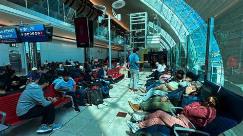 stranded passengers sleeping and waiting in Charlotte Airport terminal during storm delays
