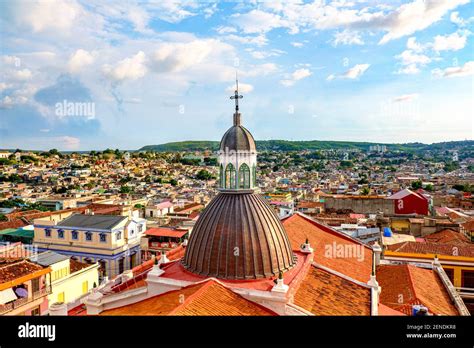 street view of Santiago de Cuba with cathedral and American tourist presence