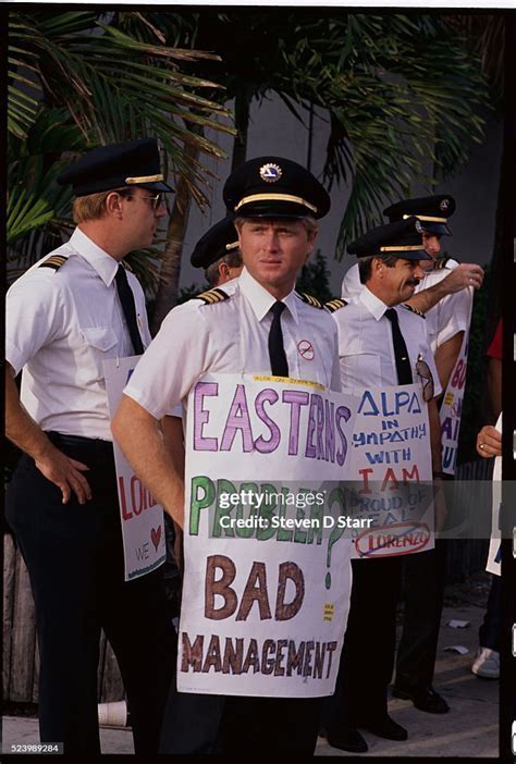 Striking Eastern Air Lines employees picketing outside an airport terminal