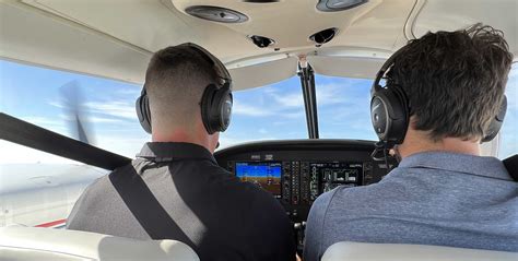 student pilot training with flight instructor in cockpit