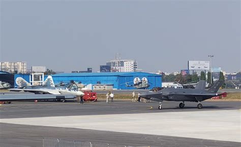 su-57 and su-30mki side by side on runway during joint military demonstration