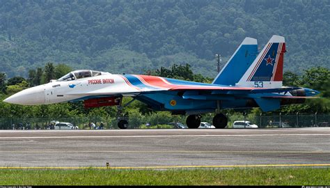 Sukhoi Su-35S flaring above forest terrain in high-speed climb with condensation trails