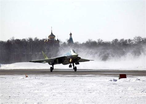 Sukhoi Su-57 Felon parked on snow-covered airbase during winter