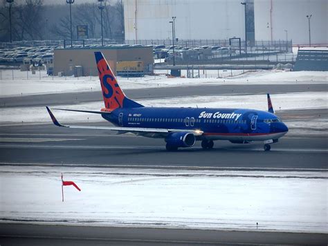 Sun Country Boeing 737 at Minneapolis airport boarding winter travelers to warm destinations