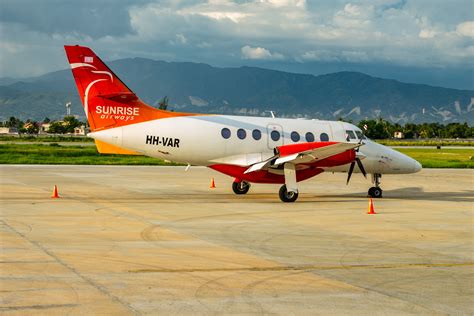 sunrise airways aircraft boarding at toussaint louverture international airport