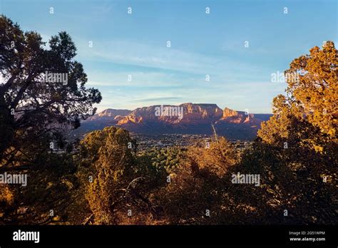 Sunset aerial view over Sedona Airport mesa with glowing Red Rock canyons