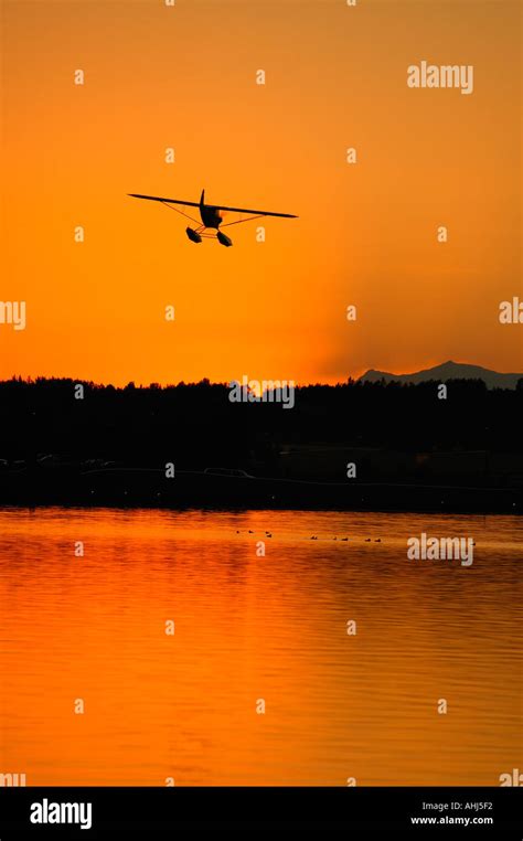 sunset at lake hood anchorage with aircraft and crowd at fly by festival finale