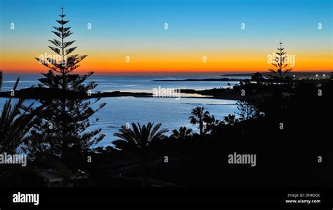 sunset over Ayia Napa beach filled with international tourists enjoying summer travel