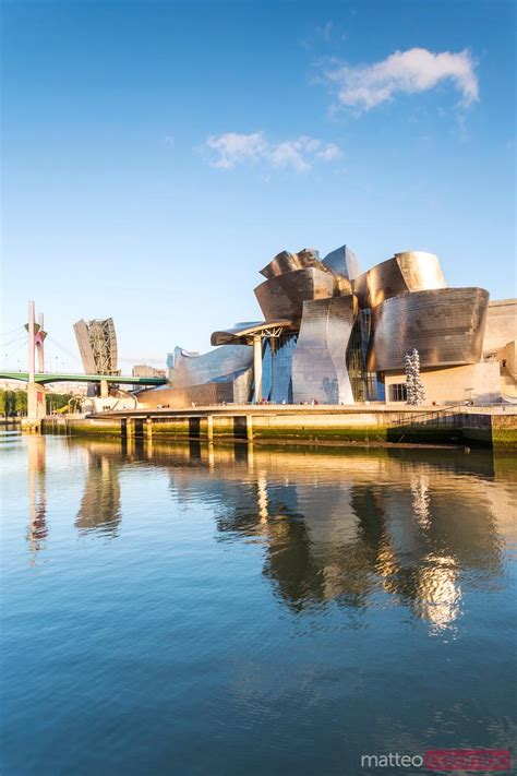 sunset over bilbao with guggenheim museum and united jet visible overhead