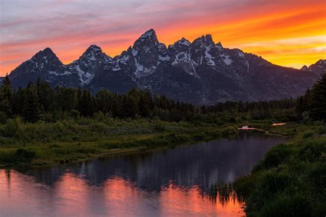 sunset view from helicopter over Teton wilderness with lens flare effect