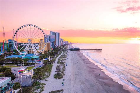 sunset view over myrtle beach boardwalk with arriving vacationers