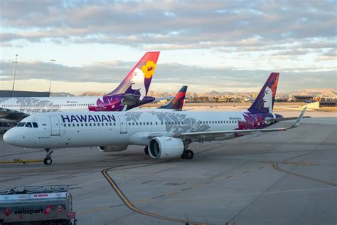surfboards being loaded onto Hawaiian Airlines aircraft at gate