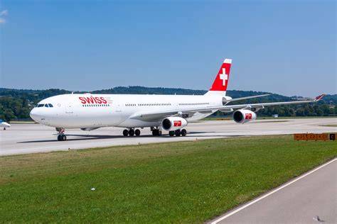 SWISS Airbus A340-300 at Zurich Airport with Swiss Alps in background