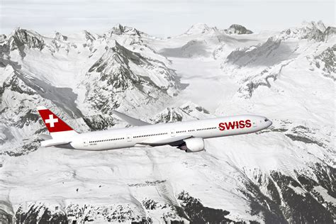 SWISS Boeing 777-300ER with alpine mountains in the background