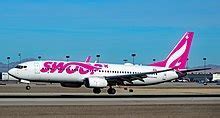 swoop airline livery with pink tail and logo on fuselage