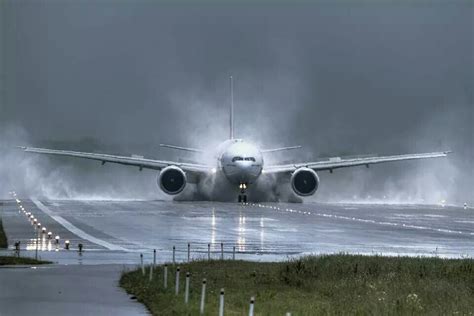 Sydney Airport under stormy skies with grounded aircraft during nationwide weather chaos