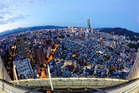 Taipei city skyline with 101 Tower at night and visible Starlux branding in air