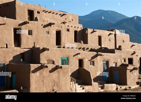 Taos New Mexico adobe buildings with mountain backdrop