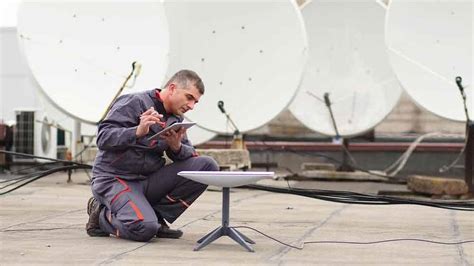 technician installing Starlink receiver on aircraft fuselage