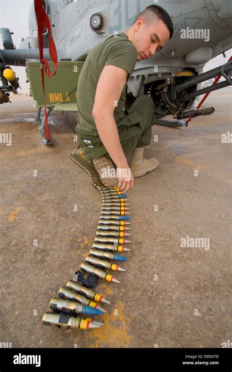 Technician loading 20mm rounds into the F-22 ammunition system
