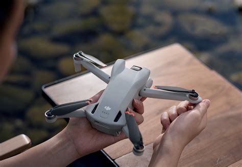 teen repairing DJI Mini 3 drone propeller after snowboarding session