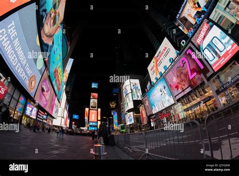 Times Square at night filled with tourists and bright billboards