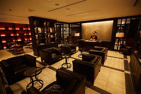 tokyo haneda jal first class lounge red suite interior luxury library bar