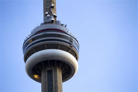 Tourists at CN Tower with summer skyline of Toronto in background
